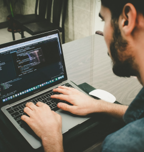 Person coding with MacBook Pro