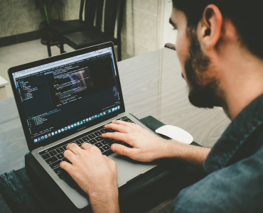 Person coding with MacBook Pro