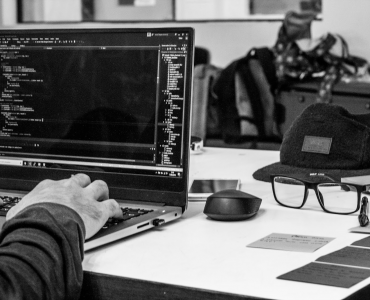 Person writing code on laptop