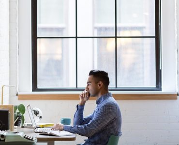 Man Coding on Laptop