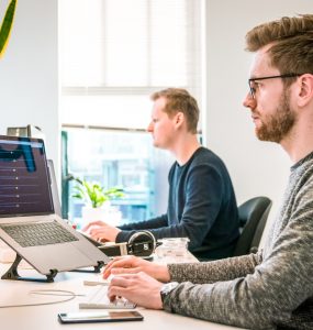 Man Coding on Laptop