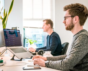 Man Coding on Laptop