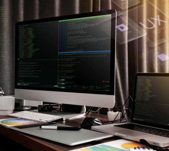 Monitor and a Laptop Against the Backdrop of Code