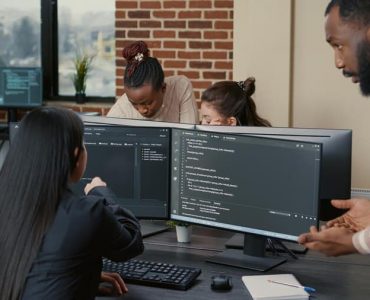 Team in Office Discussing Code