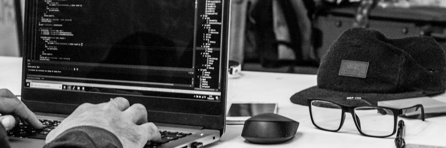 Person writing code on laptop