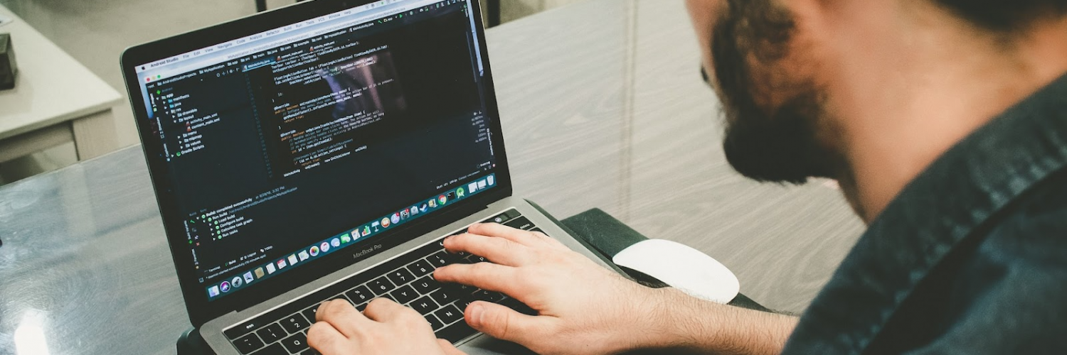 Person coding with MacBook Pro