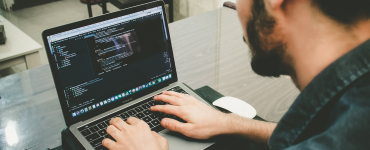 Person coding with MacBook Pro