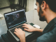 Person coding with MacBook Pro
