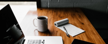 laptop developing with cup of coffe