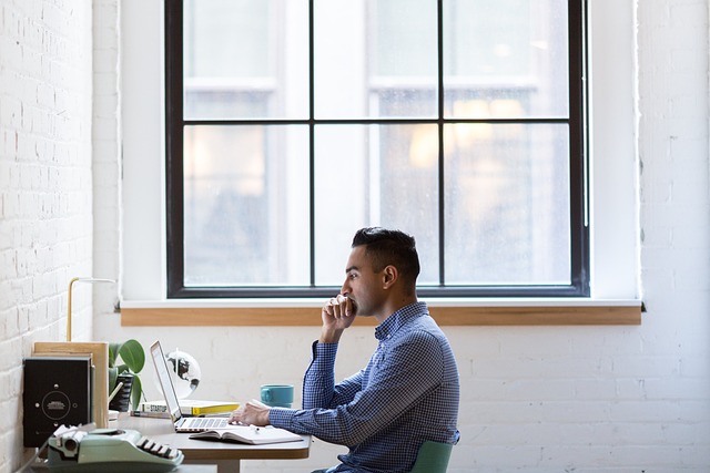 Man Coding on Laptop
