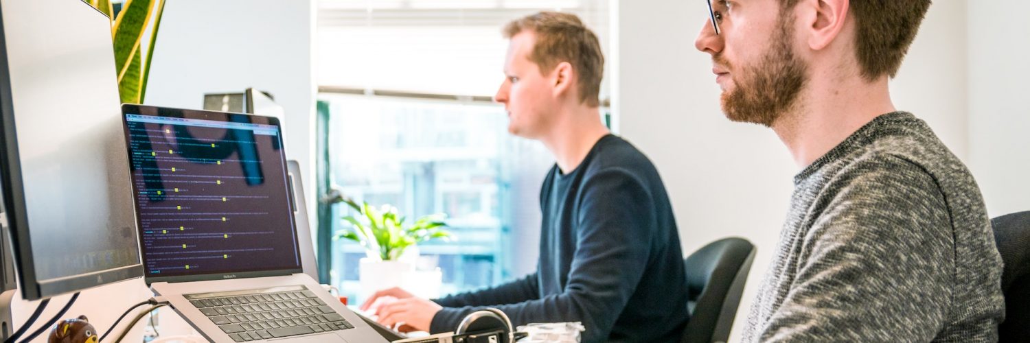Man Coding on Laptop