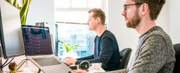 Man Coding on Laptop