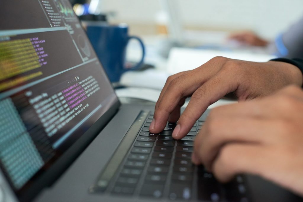 Close up of man typing code
